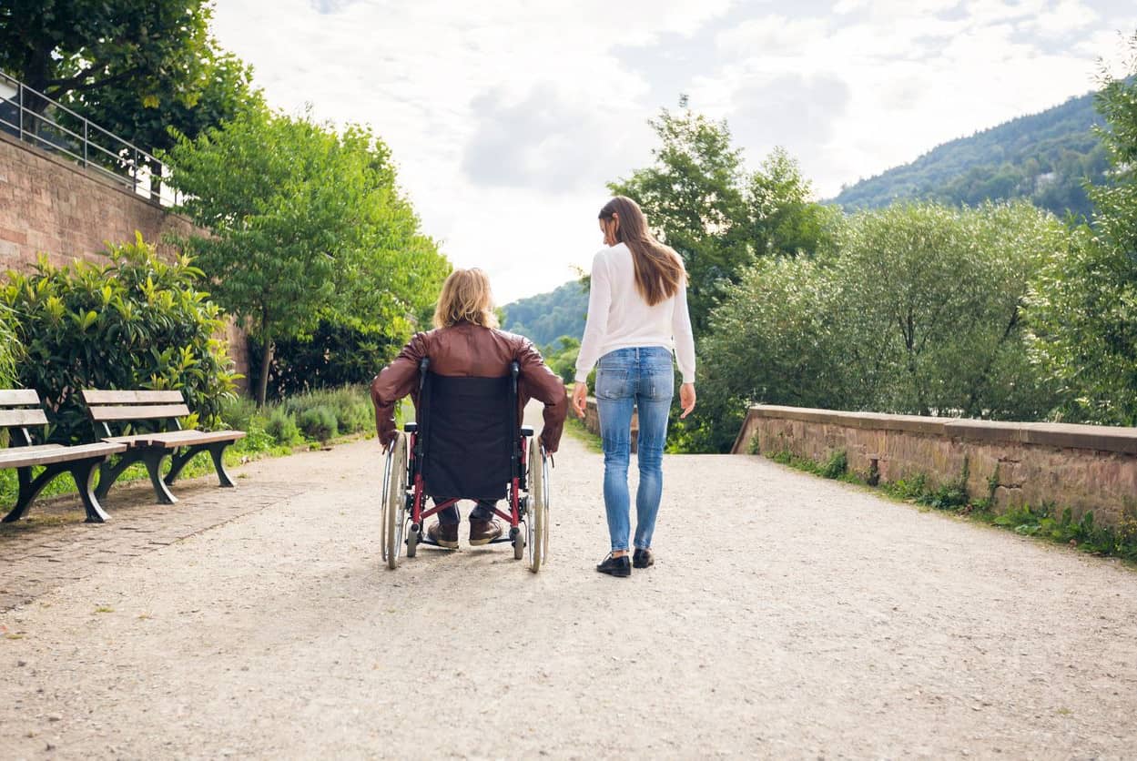 Young couple in wheelchair taking a walk